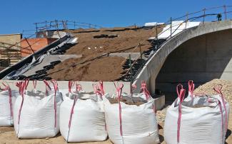 The ZinCo system build-up with Georaster®, Floraset FS 75 or Floradrain® FD 40-E was used, depending on the particular roof pitch. Substrat is being applied on a pitched green roof